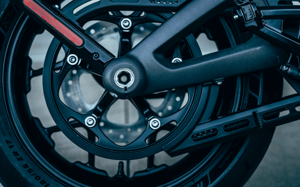 close up view of a motorcycle wheel, showcasing the spokes,tire, and the mechanical components